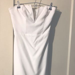 Whit V-neck Bebe dress w/ lace bottom.